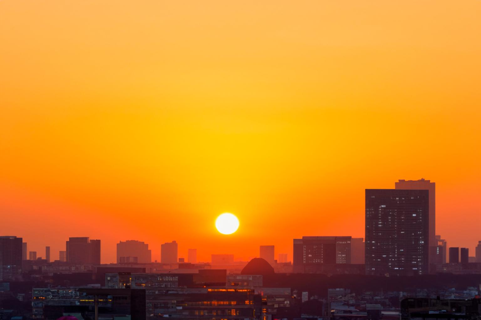 Hazy sunset with dark buildings
