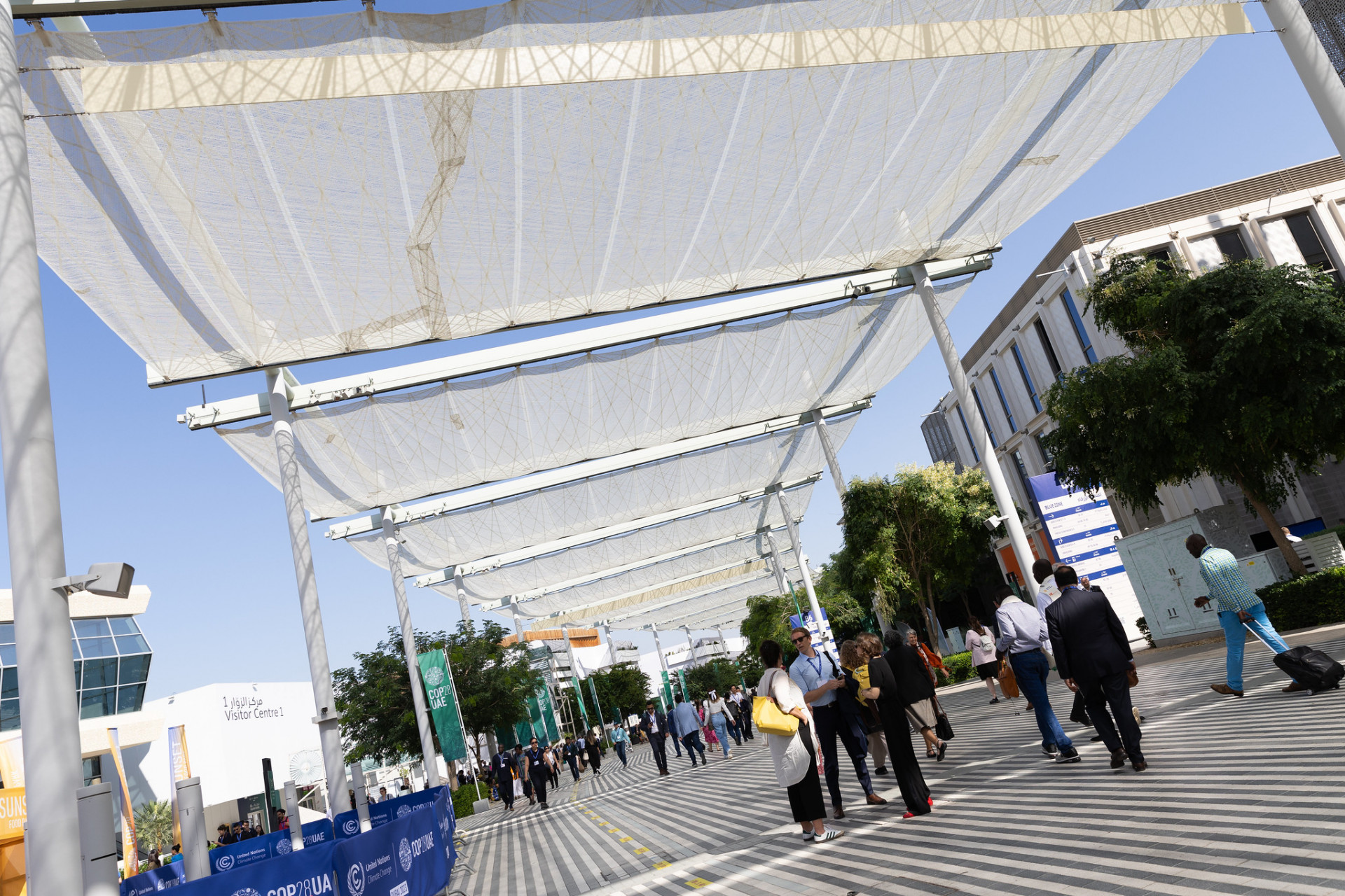 Participants walk through the COP28 venue