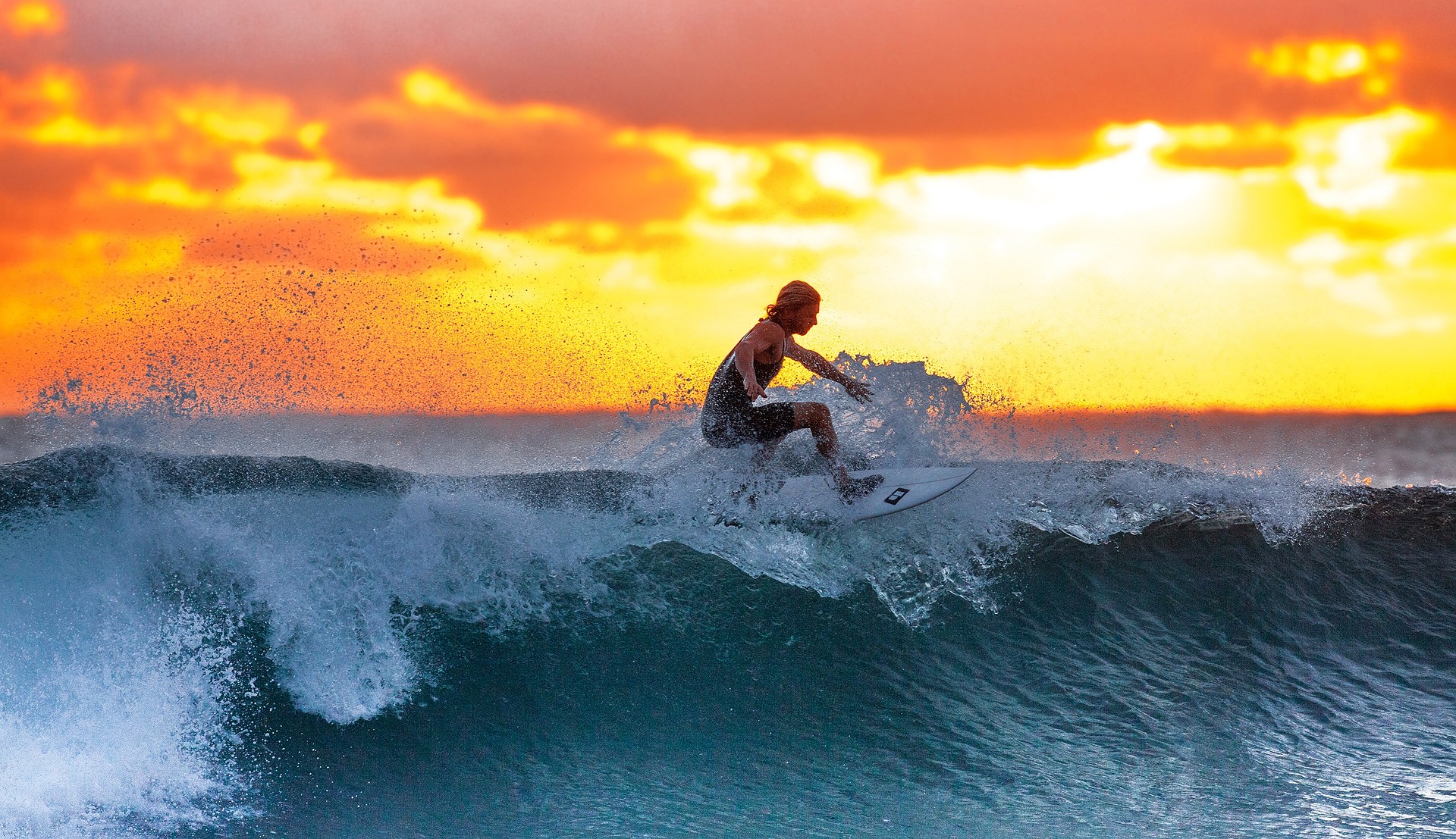 A surfer rides a wave.