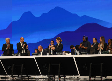 Delegates at COP27 celebrate the end of the conference up on the main podium.