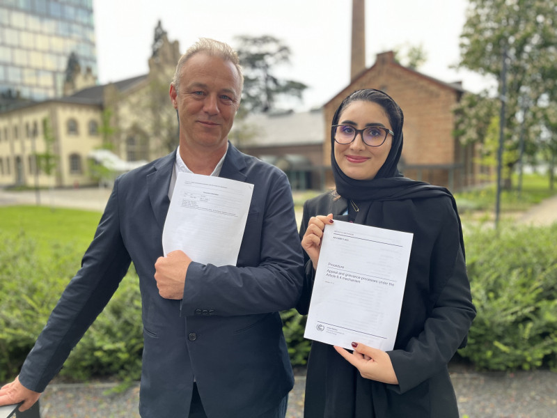 Maria AlJishi (right) and Martin Hession (left), Chair and Vice Chair of the Article 6.4 Supervisory Body, hold the text that was agreed, which introduces the Appeals and Grievances Procedure.